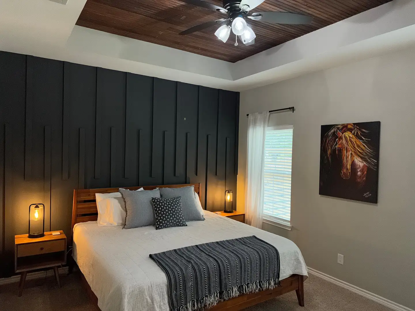 King bedroom with dark accent wall