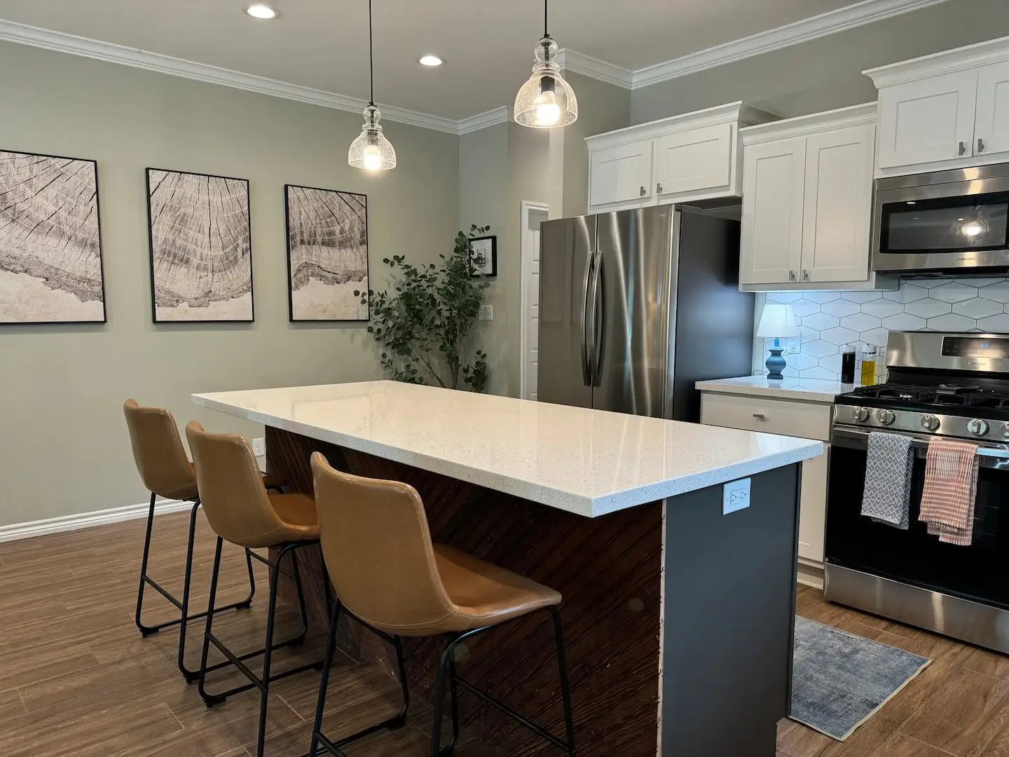 Kitchen island with bar stools and stainless appliances