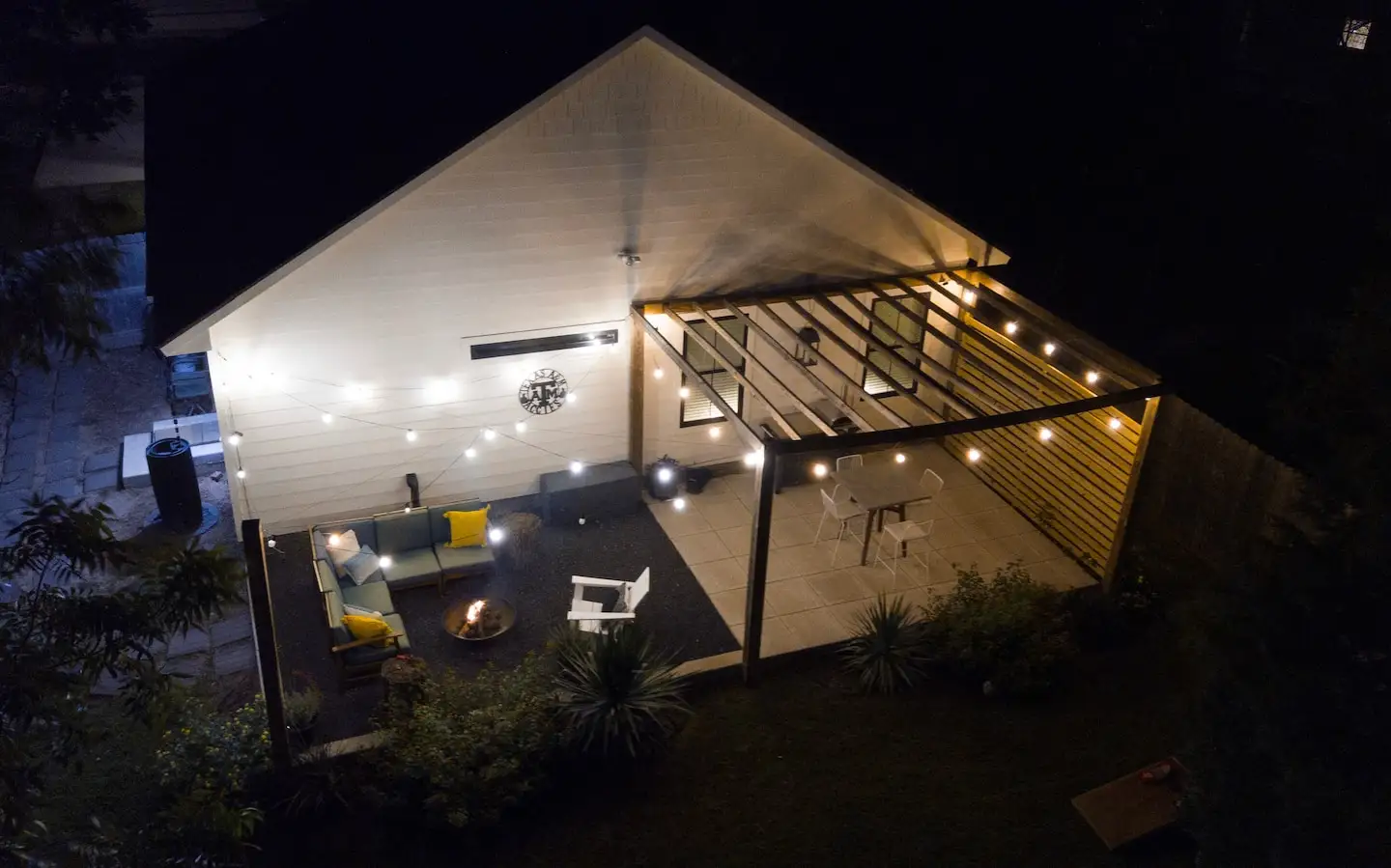 Lit-up pergola and patio at night
