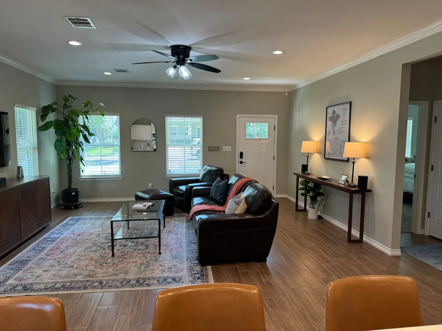 Living room with leather sofa and ceiling fan